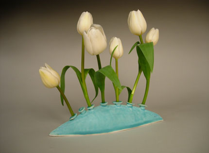 untitled vase with seven openings, holding 6 white tulips